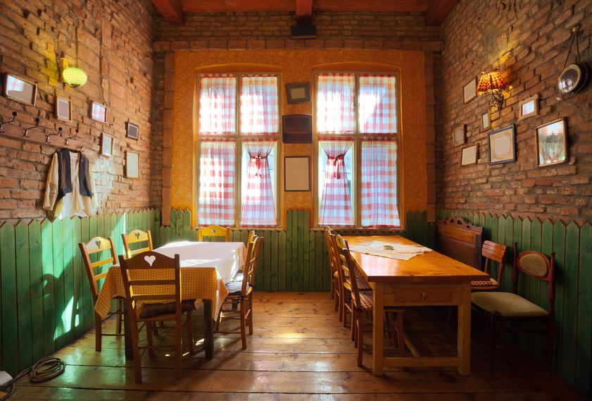 9168961 - interior of an old tavern, traditional serbian style, souvenirs and old wooden furniture.